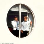 ID 1401 ENCHANTMENT OF THE SEAS (1997/74136grt/82910grt after lengthening in 2005/IMO 9111802) - Crew members take in the quayside views as the newly launched cruiseship berths in Southampton for a...